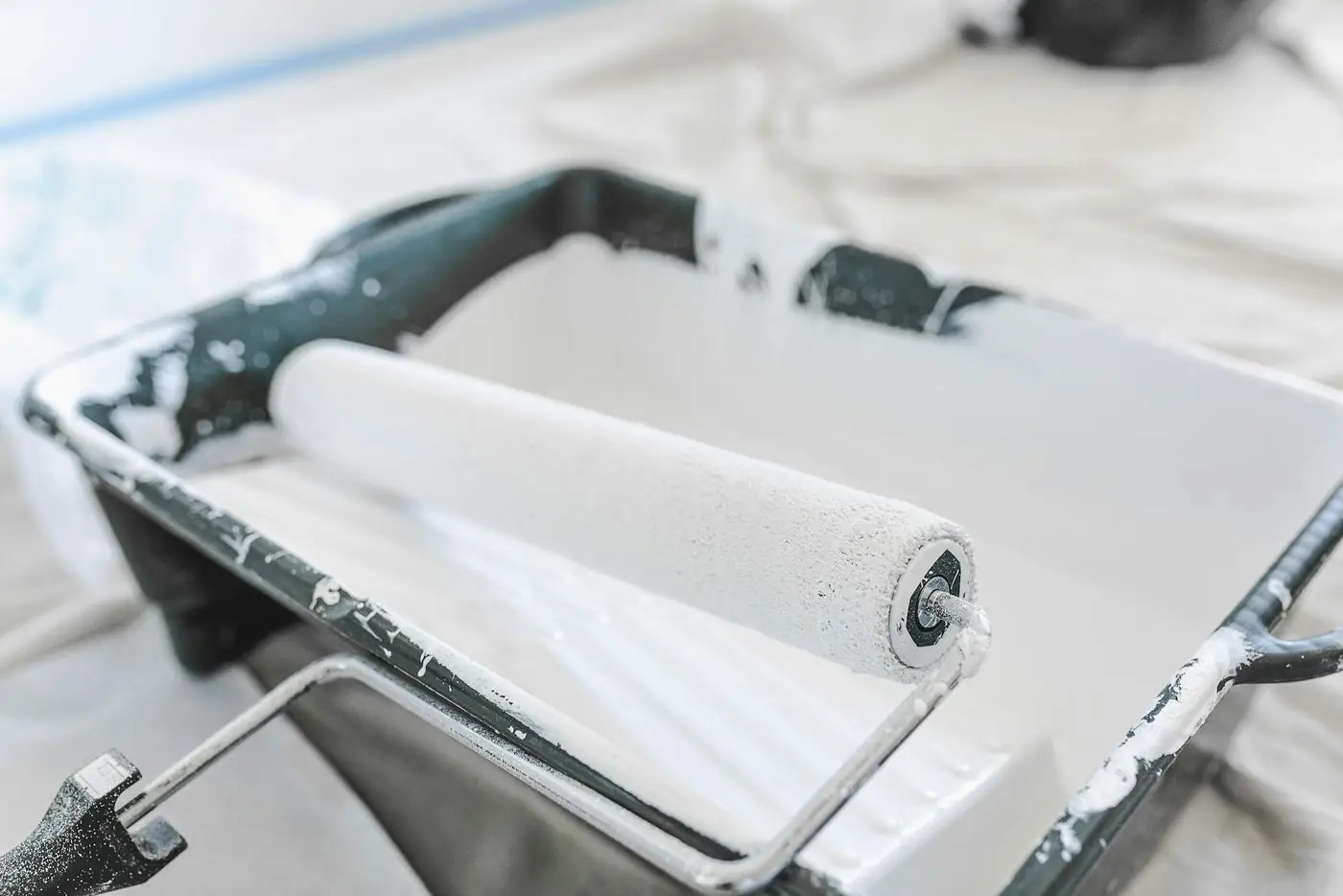 Paint roller loaded with white paint