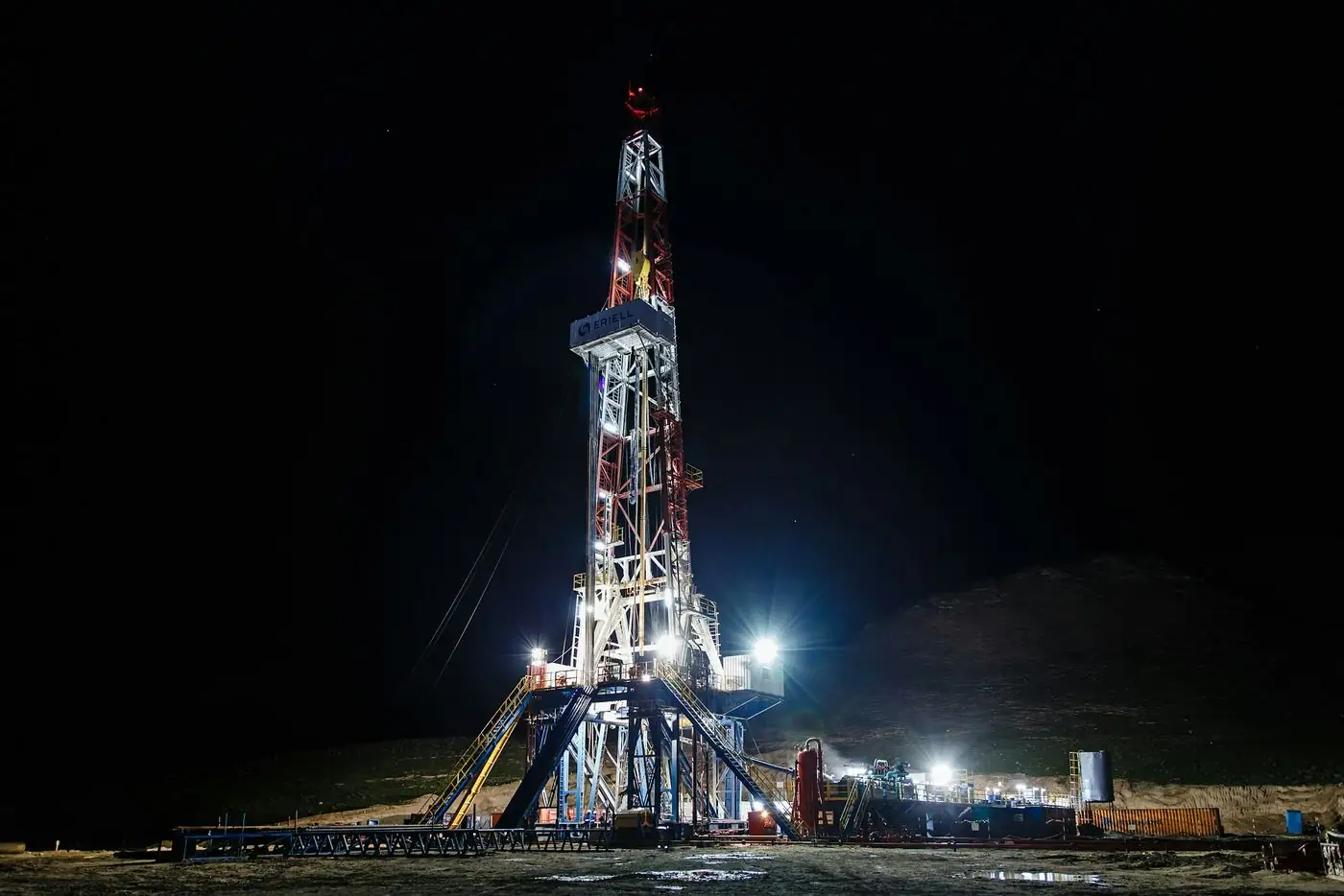 Onshore drilling rig lit up at night